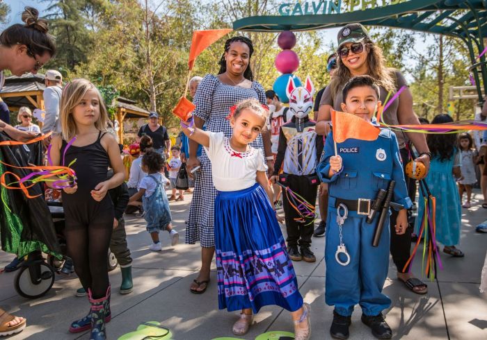 Group of children dressed in costumes during Halloween Trick or Treat parade in Pasadena California